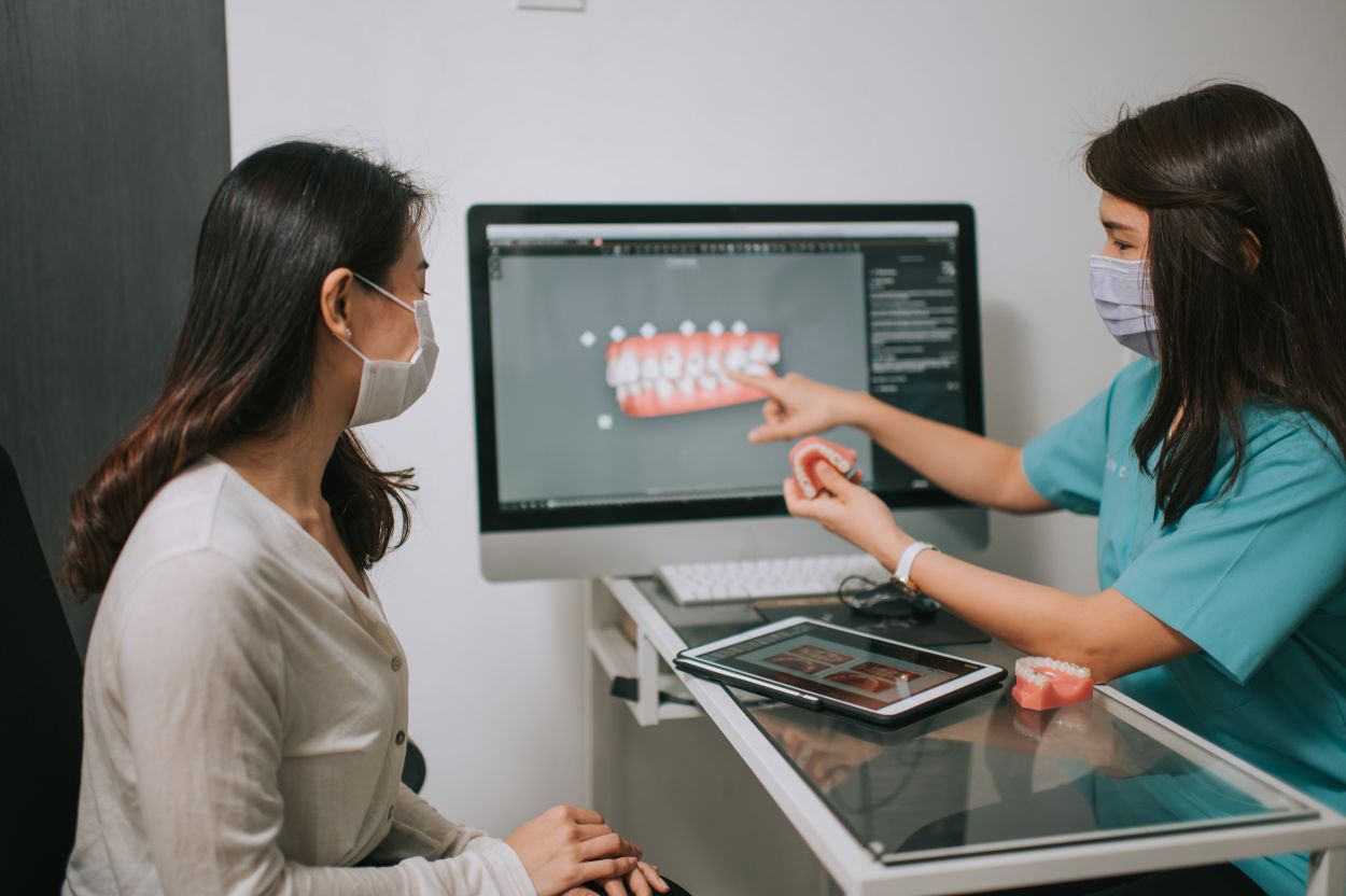 Dentist discussing cosmetic dentistry treatment options with a patient during a consultation