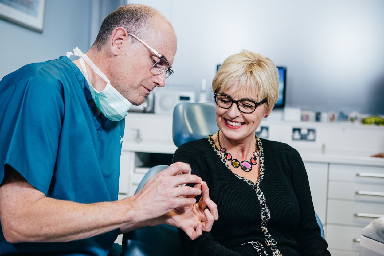 Dentist talking with a patient during a facial aesthetics consultation at Acorn Dental Health